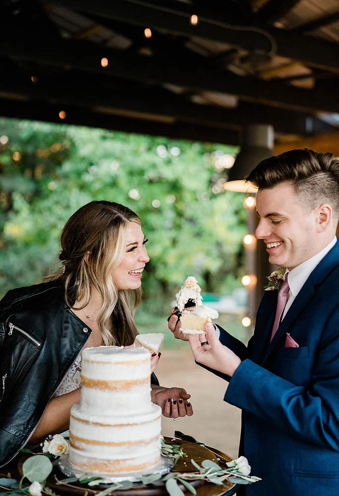 real stella york bride and groom cutting wedding cake - style 6648 by stella york
