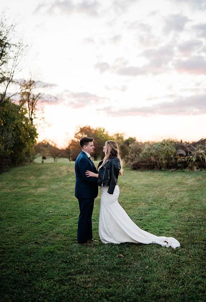 real stella york bride wearing leather jacket over wedding dress - style 6648 by stella york