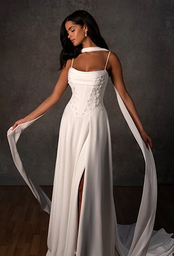 Bride wearing a-line wedding dress with high leg slit and thin spaghetti straps