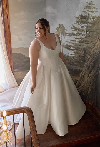 Bride wearing ballgown satin wedding gown with straps and v-neckline
