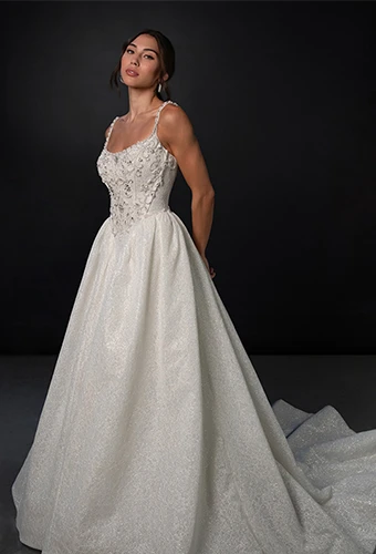 Bride wearing sparkling tulle wedding dress with thin straps