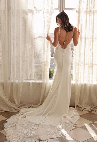 Bride wearing crepe wedding dress with illusion back and lace train