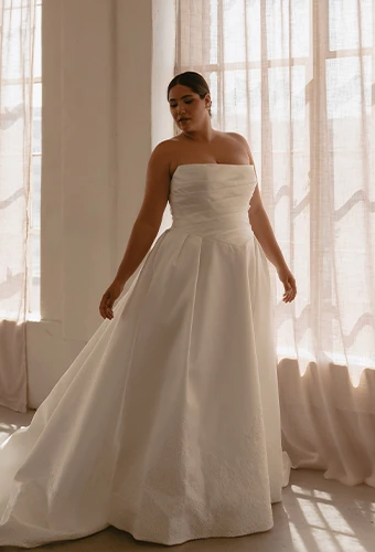 Plus size bride wearing strapless silk wedding gown