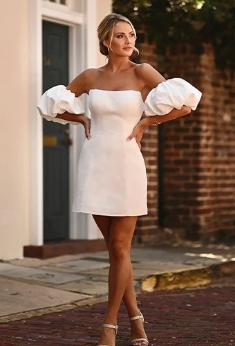Bride wearing strapless mini wedding dress with puff sleeves