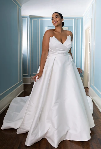 Bride wearing wedding dress with ballgown overskirt and sweetheart neckline
