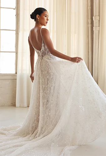 Bride wearing sparkling art deco lace wedding dress with spaghetti straps and low back