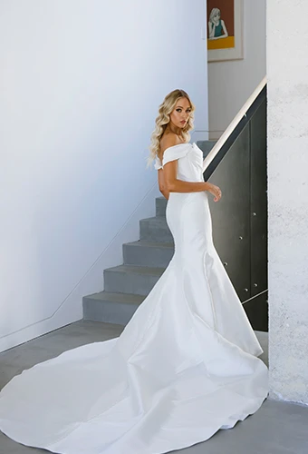 bride posing over shoulder in simple satin off the shoulder wedding dress - 1486 by Martina Liana