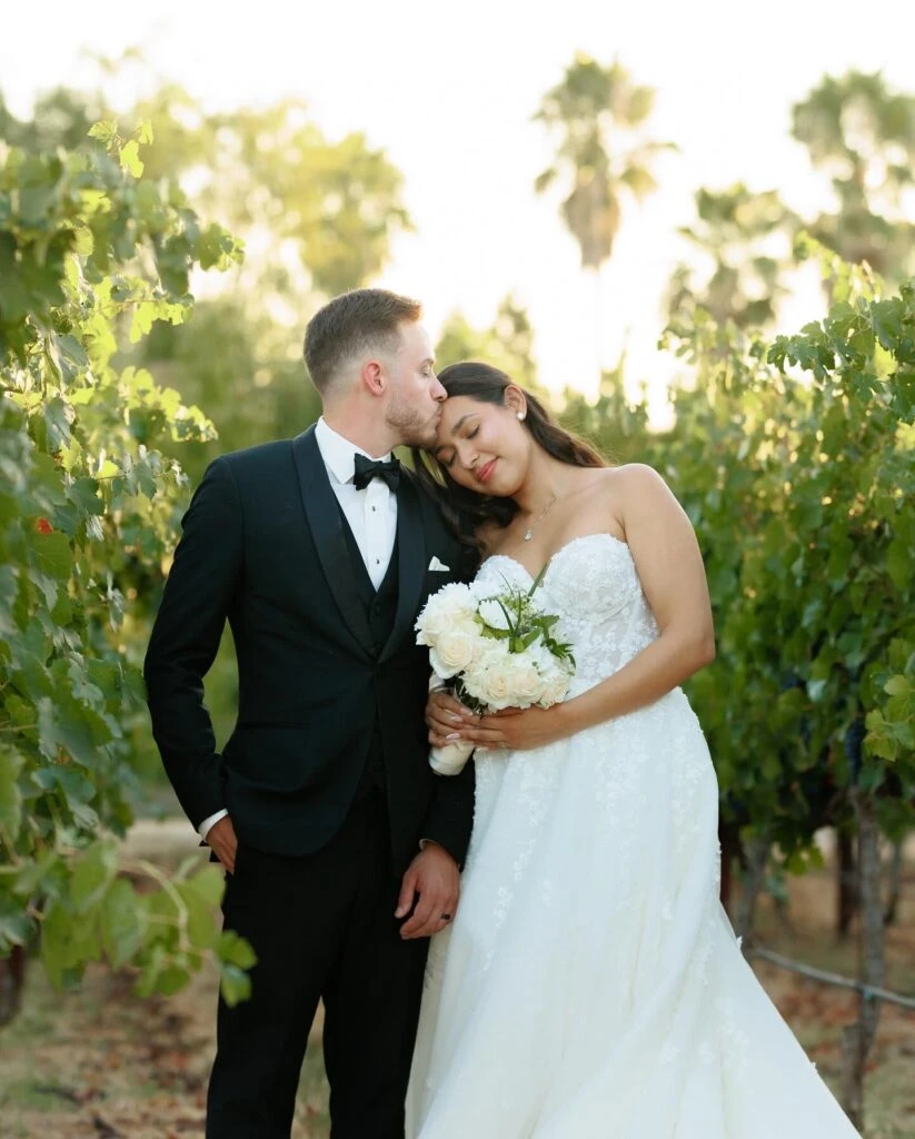real bride mailin posed laying her head on husbands shoulder in garden - Style 1483 by Martina Liana