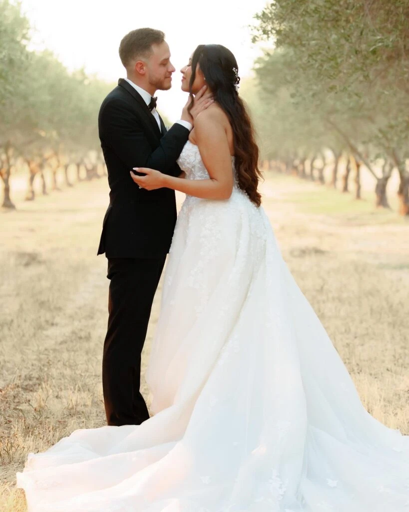 real bride mailin posed face to face with husband in a field - Style 1483 by Martina Liana