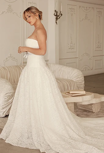 Bride wearing strapless wedding dress with drop waist