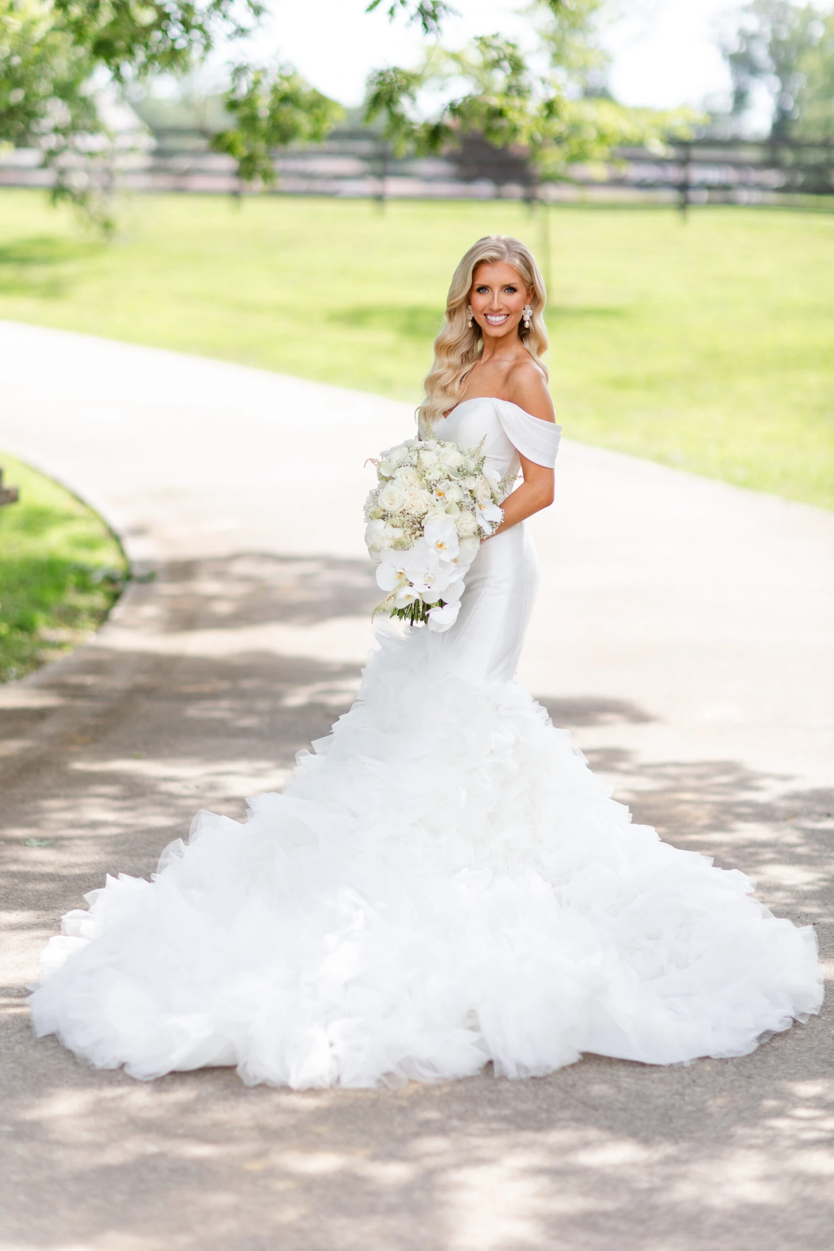 real bride jadah posing on a dirt path holding bouquet wearing 1611 by Martina Liana