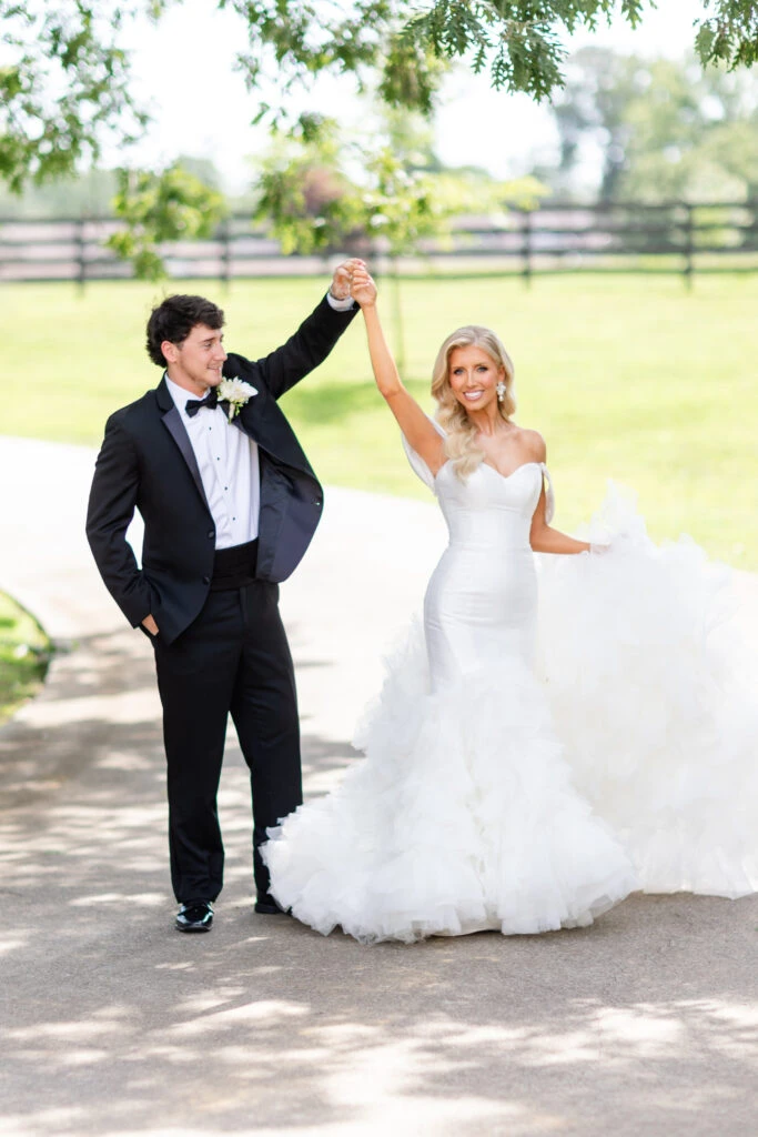 jadah holding up clasped hands with husband wearing 1611 by Martina Liana