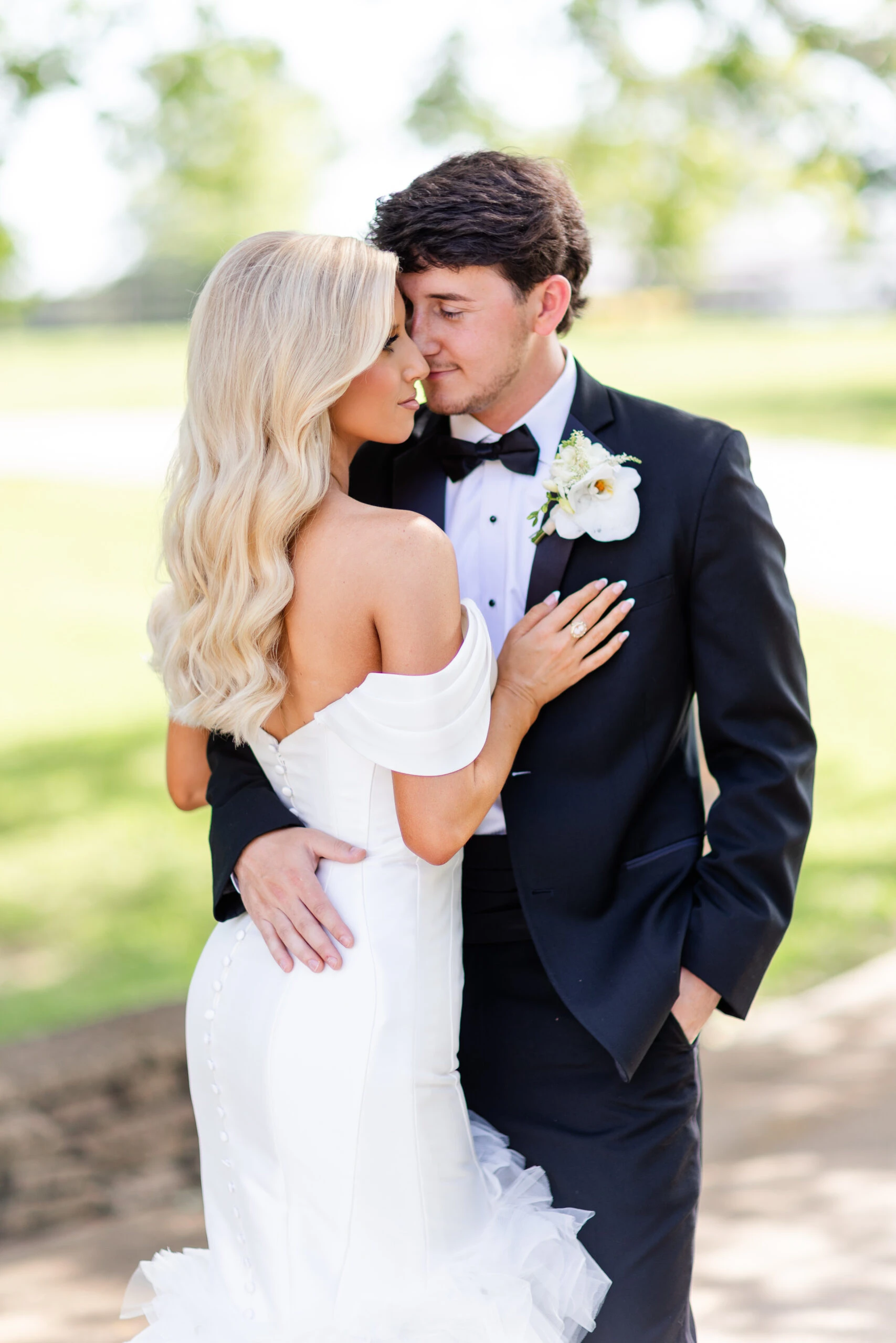 real bride Jadah posing face to face with husband wearing 1611 by Martina Liana