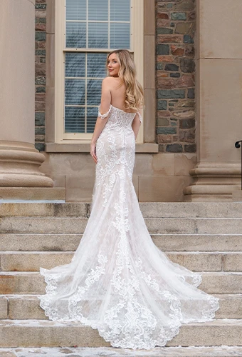 Bride wearing vintage-inspired fit-and-flare lace wedding dress with drapey off-the-shoulder straps