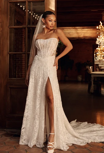 Bride wearing sparkling strapless a-line wedding dress with high leg slit