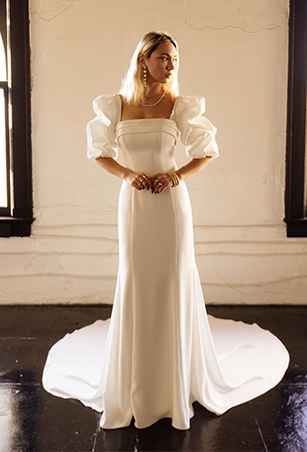 Bride wearing simple wedding dress with square neckline and detachable sleeves