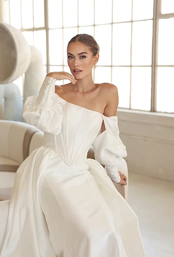 bride sitting on chair wearing satin off the shoulder wedding gown - LE1392 by Martina Liana Luxe