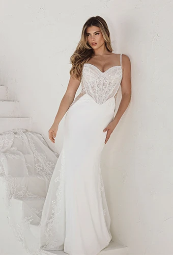 Bride wearing column wedding dress with spaghetti straps and sheer bodice