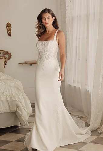 Bride wearing lace column wedding dress with corset bodice