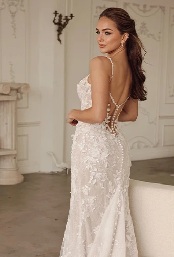 Bride wearing lace fit-and-flare wedding dress with spaghetti straps