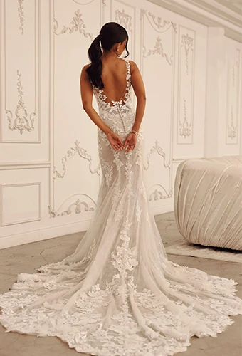 Bride wearing lace fit-and-flare wedding dress with low back