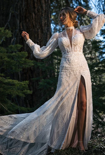 Bride wearing long sleeve lace wedding dress with high leg slit and plunging neckline