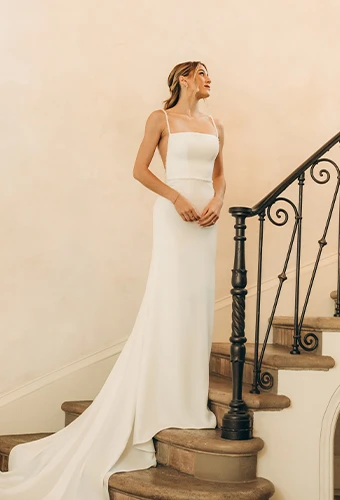 Bride wearing simple column wedding dress with spaghetti straps