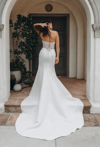 Bride wearing strapless wedding dress with side cutouts