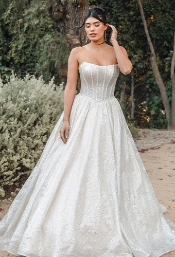 Bride wearing glittering strapless ballgown wedding dress