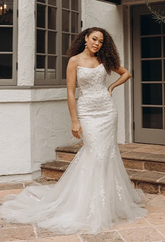 Bride wearing lace corset wedding dress with detachable sleeves