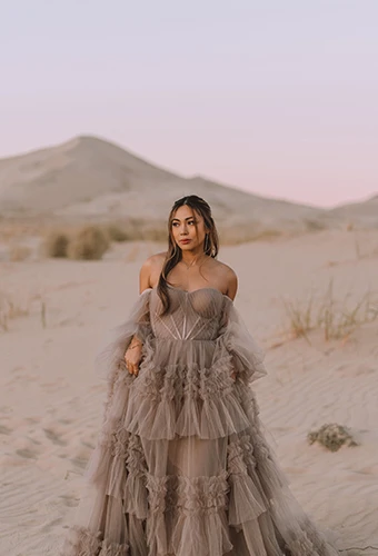 bride wearing tan tulle wedding dress with off the shoulder sleeves - sutton by all who wander