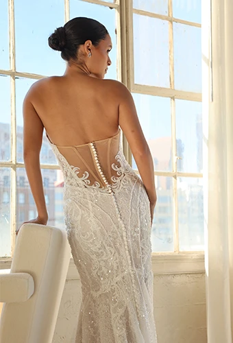 Bride wearing art deco strapless wedding dress with sparkling lace and sheer back