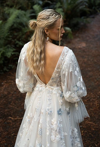 Bride wearing colorful lace wedding dress with blouson sleeves and low v back