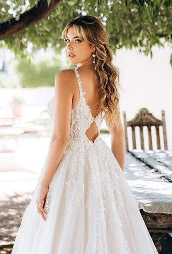 Bride wearing sparkling lace wedding dress with keyhole back