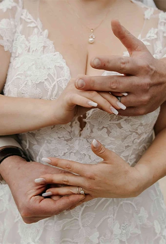 Close up hands and rings of real bride Chantal