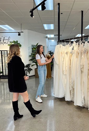 Bride and bridal stylist picking a wedding dress