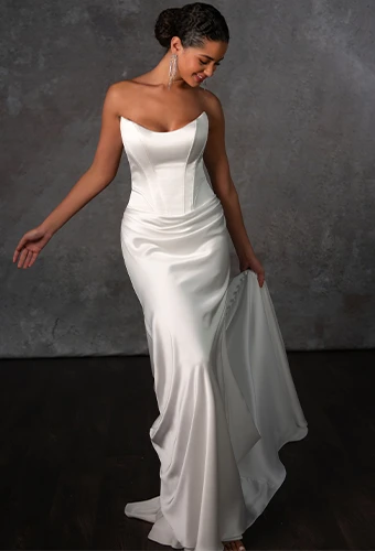 Bride wearing strapless cateye wedding dress with scoop neckline and boning