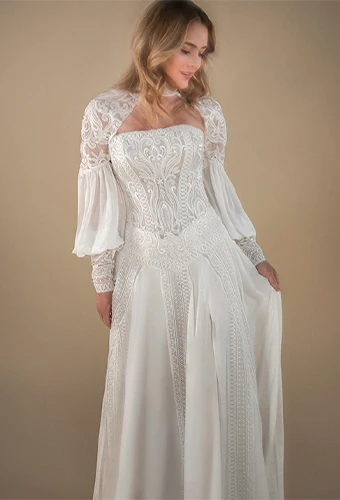 Bride wearing chiffon wedding dress with long sleeves and lace detailing