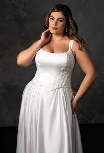 Plus size bride wearing satin ballgown wedding dress with square neckline and beaded lace