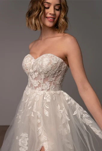Bride wearing lace strapless wedding dress with high leg slit and sweetheart neckline