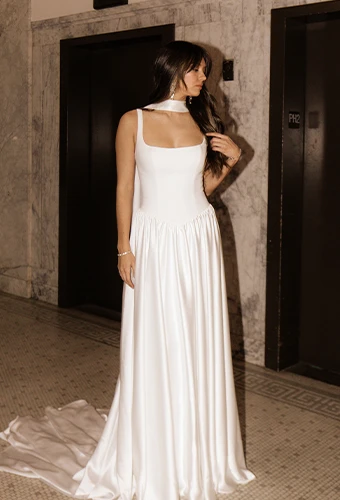 Bride wearing simple a-line wedding dress with scoop neckline and straps