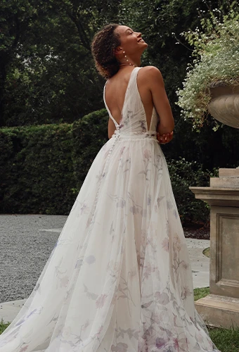 Bride wearing a-line wedding dress with v-back and floral pattern