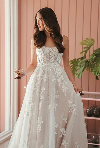 Bride wearing lace a-line wedding dress with spaghetti straps