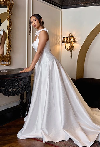 Bride wearing mikado wedding dress with bow straps