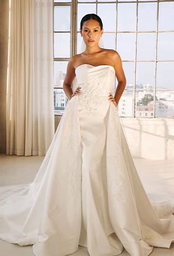 Bride wearing strapless wedding dress with overskirt