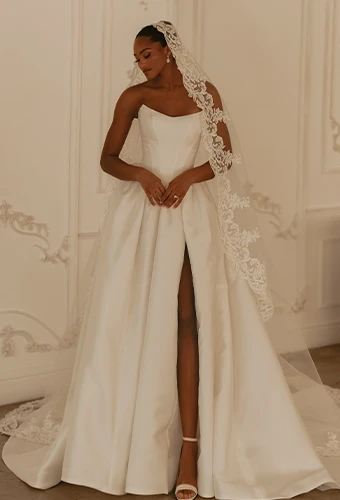 Bride wearing strapless wedding dress with overskirt