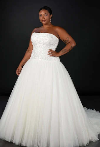 Plus size bride wearing strapless mikado wedding dress with lace bodice and a-line silhouette