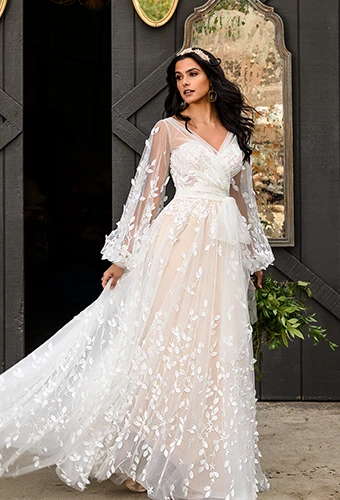Bride wearing boho floral lace wedding dress with long sleeves and sweetheart neckline