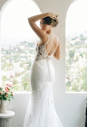 Bride wearing fit-and-flare lace wedding dress with low back