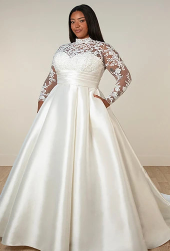 Plus size bride wearing mikado wedding dress with lace long sleeves